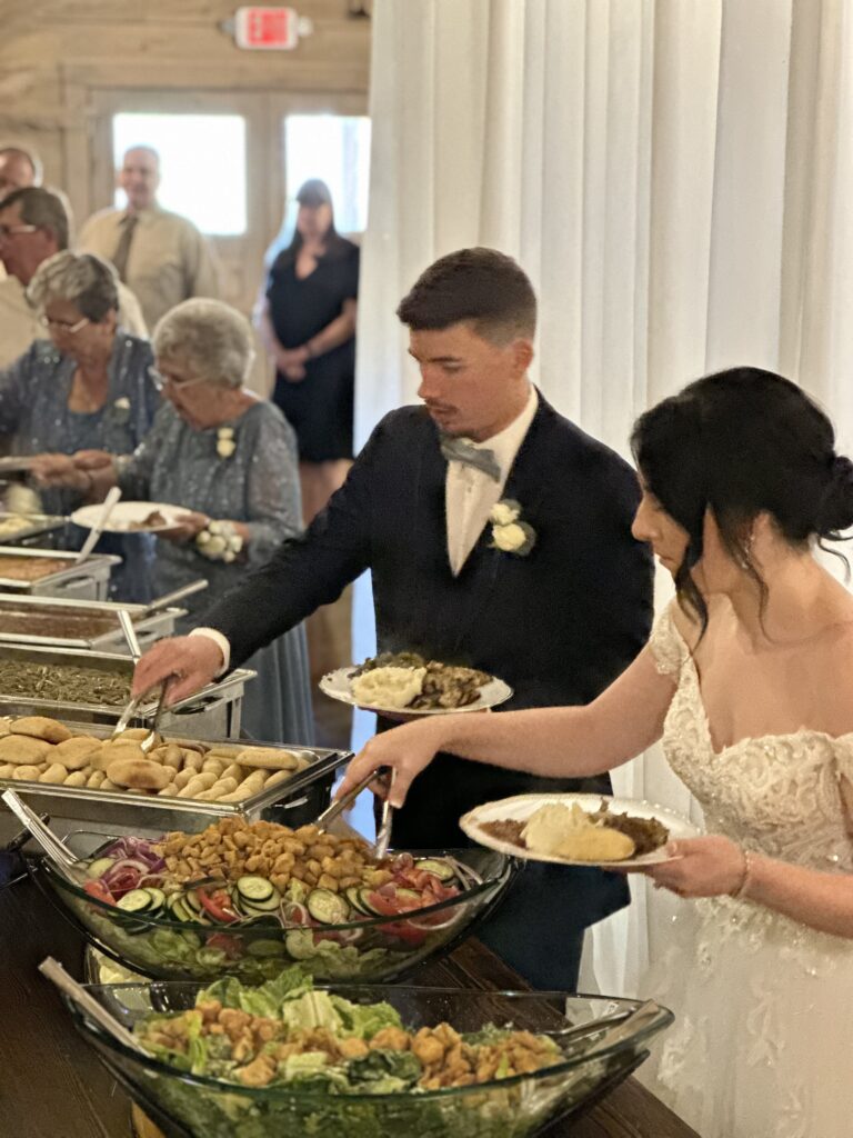 bride and groom fixing plates during wedding reception